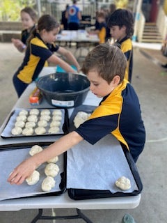 Students making bread rolls during Kids in the Kitchen