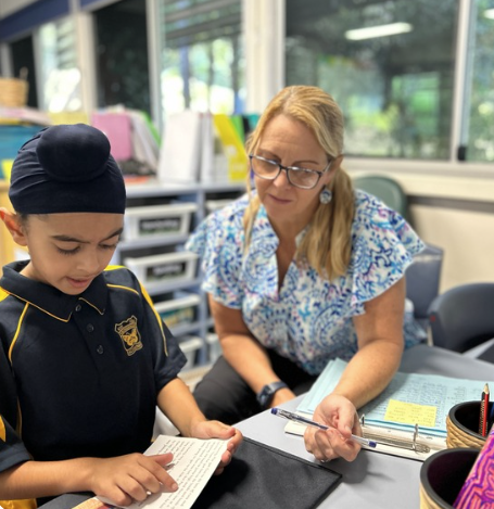 A student reading to an Student Learning Support Officer (SLSO)
